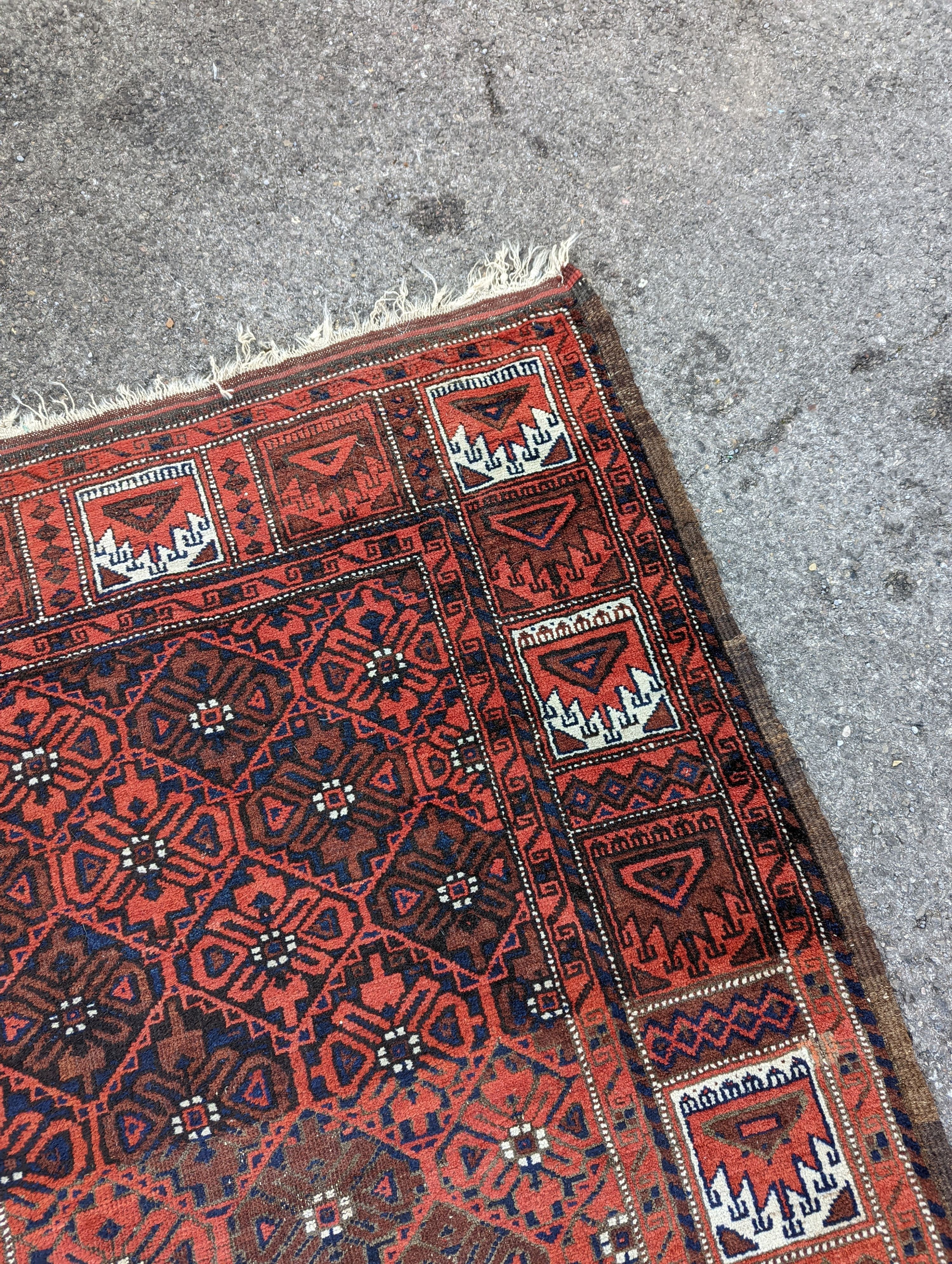 A Turkish red ground rug, 212 x 106cm